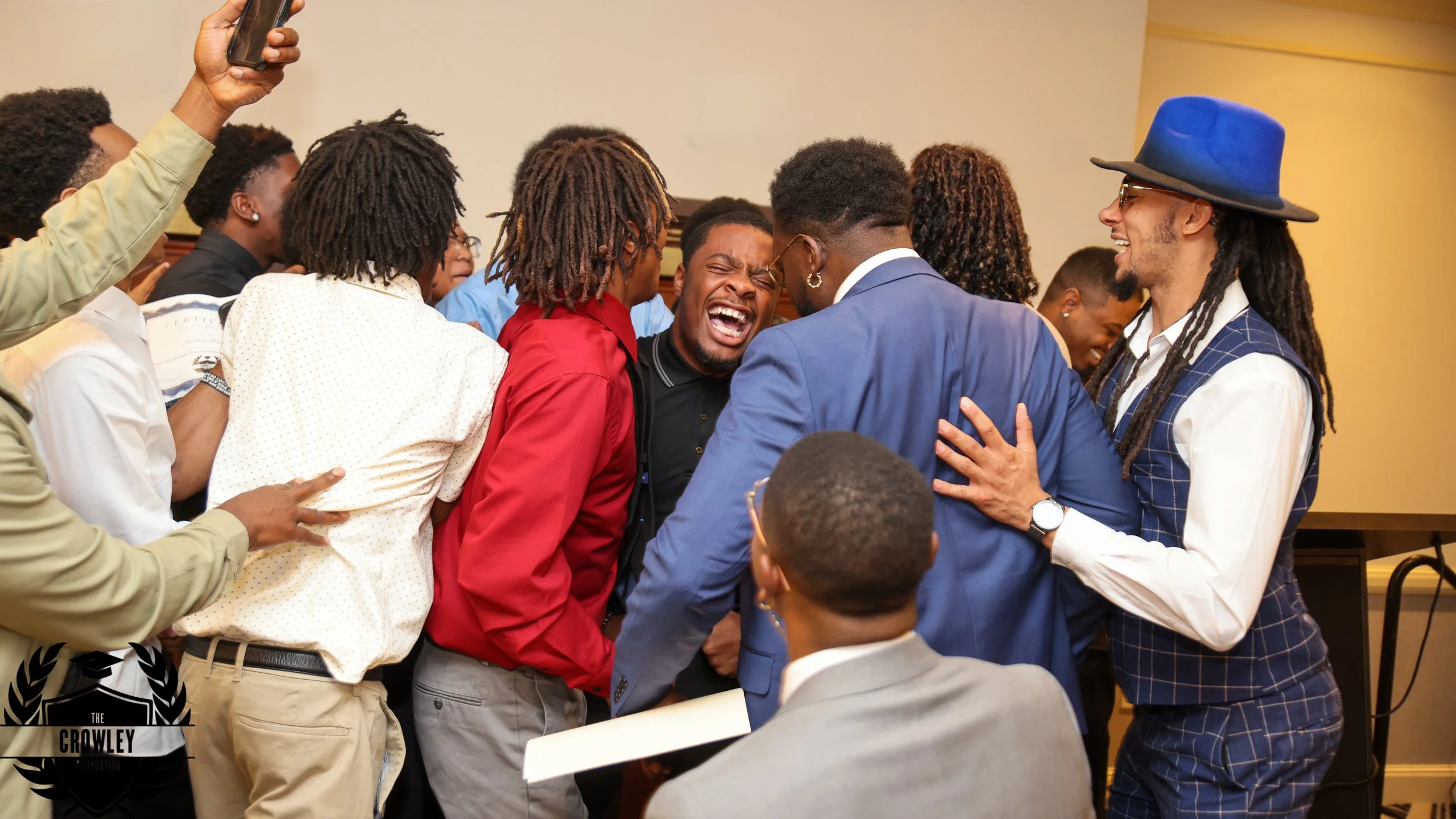 Young men celebrating together at a Crowley Foundation event